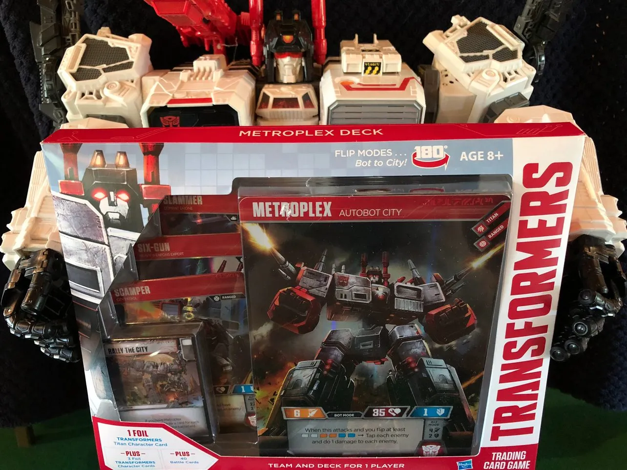 Generations Metroplex holding the Transformers TCG Metroplex Deck